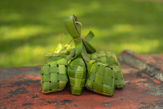 Tumpukan ketupat segar yang baru matang, siap disajikan dengan berbagai hidangan Lebaran. Anyaman janur yang rapi melambangkan kesucian dan tradisi yang telah diwariskan turun-temurun di Indonesia.