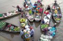 Para pedagang lokal sibuk menjajakan dagangan mereka dari atas perahu tradisional, menciptakan pemandangan khas pasar terapung yang ramai dan penuh warna di pagi hari. Aktivitas ini menunjukkan interaksi sosial dan ekonomi yang telah menjadi bagian integral dari kehidupan masyarakat setempat selama berabad-abad.