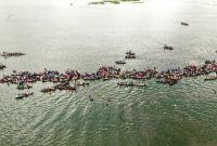 Pemandangan Sungai Barito dari udara memperlihatkan jalur air yang membelah hutan lebat, menjadi arteri utama kehidupan di Pulau Kalimantan. Perahu-perahu tradisional tampak berlayar pelan, menyusuri riak Barito yang menyimpan ribuan cerita.