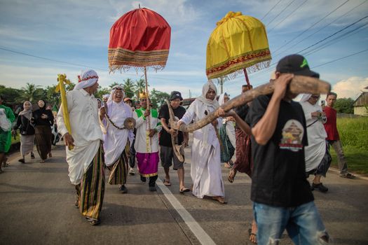 Anak-anak diayun dalam ritual Baayun Mulud yang sarat makna, dihiasi janur kuning dan berbagai ornamen, menjadi pemandangan khas perayaan Maulid Nabi di Kalimantan Selatan. Prosesi ini merupakan wujud doa dan harapan orang tua demi kebaikan sang buah hati.